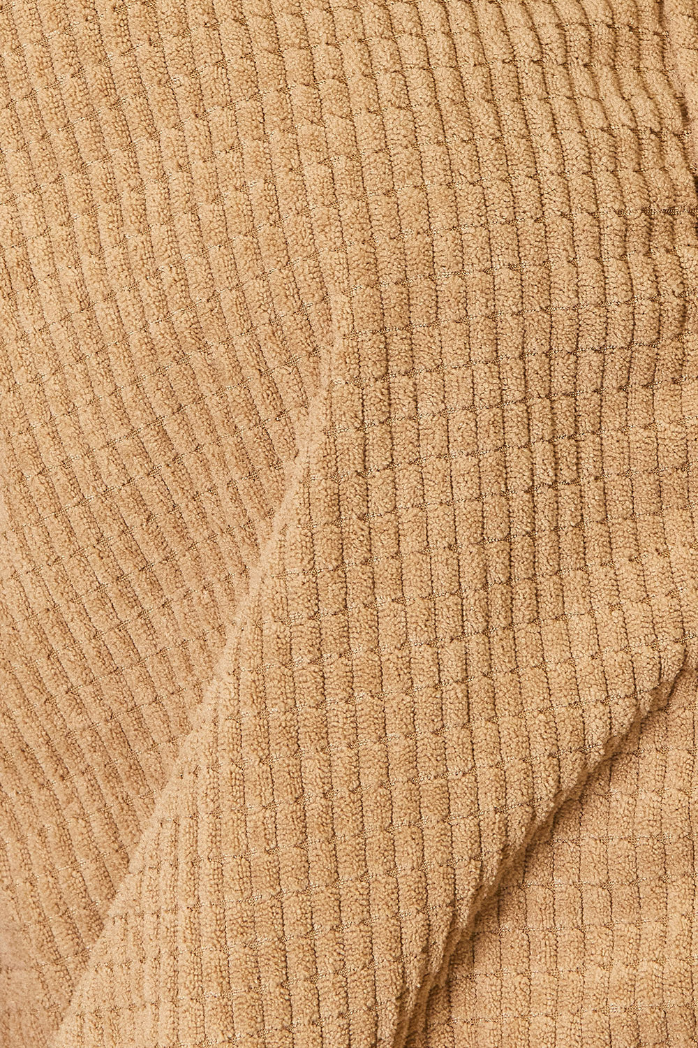 Close-up of the camel textured fabric on the Fleur jacket